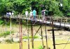 যুগের পর যুগ কাঠের নড়বড়ে সেতুতে পারাপার